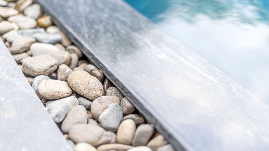 An image of pebble border of a fibreglass pool