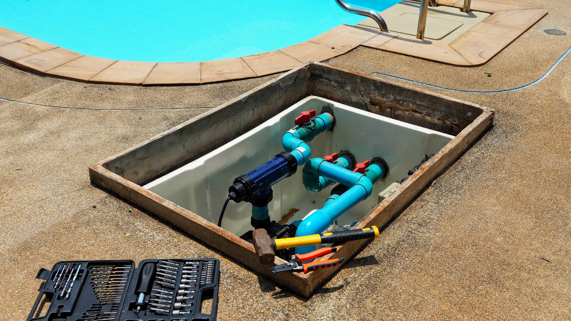 A pool pump being fixed, with part of the plumbing system is shown