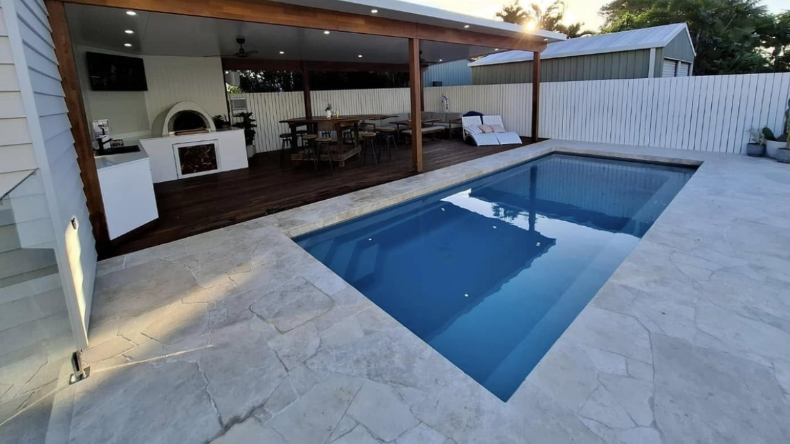 An image of a fibreglass pool with patio, installed and taken by the Pool Professionals Mackay