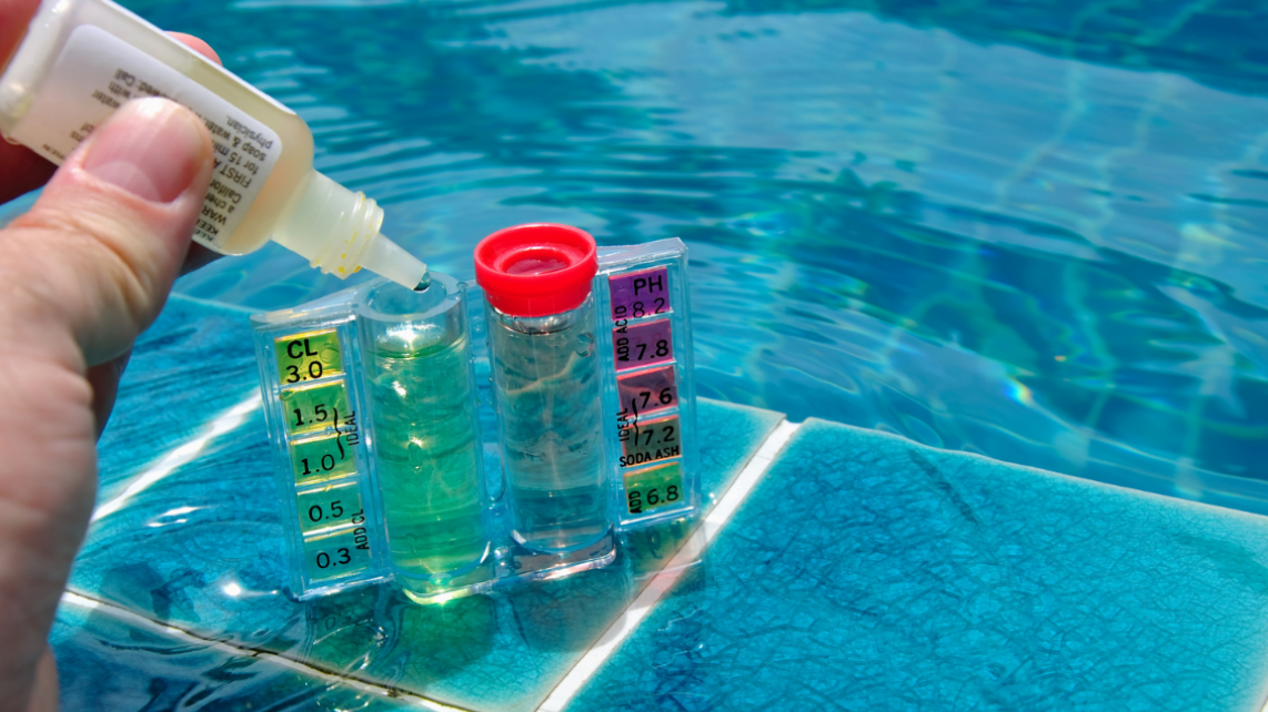 An image of a hand doing a pool water chemistry test